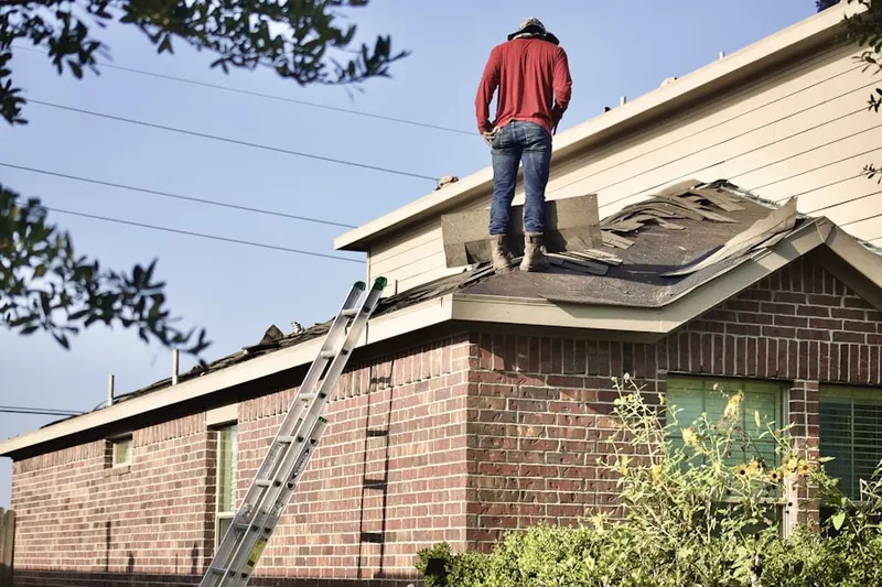 Professional roofer working on a residential roof in Hueys Corners